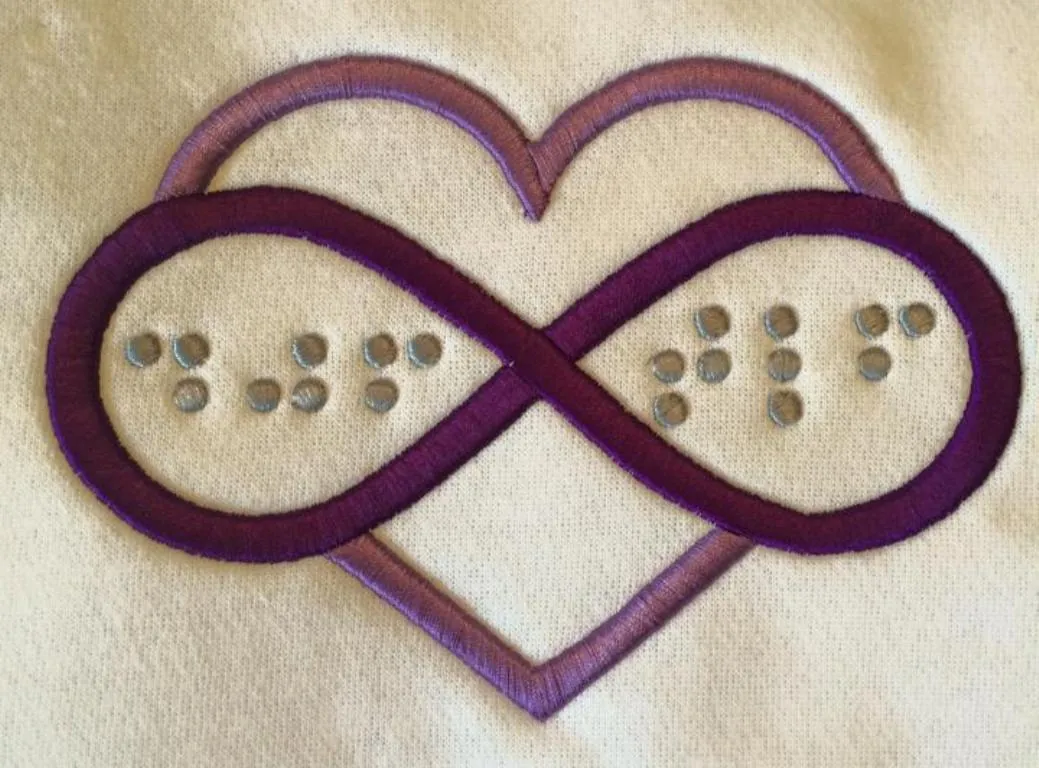 Heart and infinity monogram embroidered in braille with puff foam