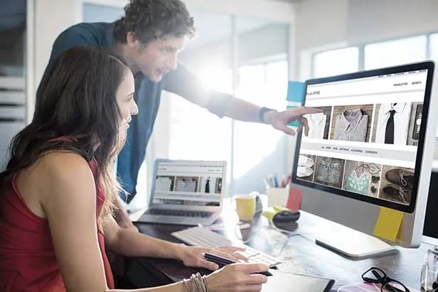 Two people browsing an online store on a computer