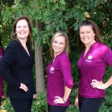 Team wearing custom embroidered magenta polo shirts