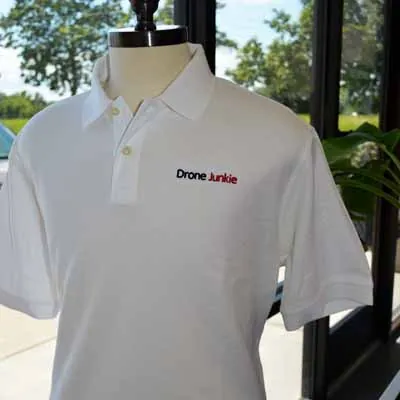 White polo with an embroidered Drone Junkie logo
