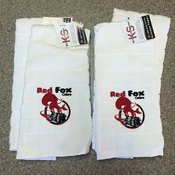 Red Fox logo embroidered on white hand towels