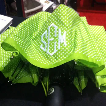 Monogram embroidered on a neon green polka dot umbrella