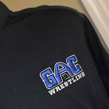 GAC Wrestling logo embroidered on a black jacket
