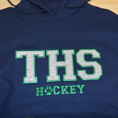 THS Hockey lettering embroidered on a navy hoodie