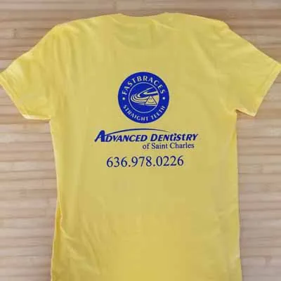 Advanced Dentistry of Saint Charles logo printed on a yellow tee