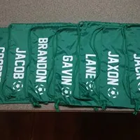 Green drawstring bags personalized with vinyl names